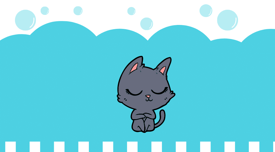 黒猫がひざを抱えて座っている。
